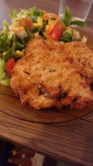 Portobello-filled escalope with salad. at Veggira in Bilbao