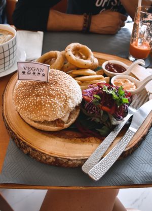 BBQ vegan cheese burger with onion rings, French fries, side salad  at May Veggie Home in Bangkok