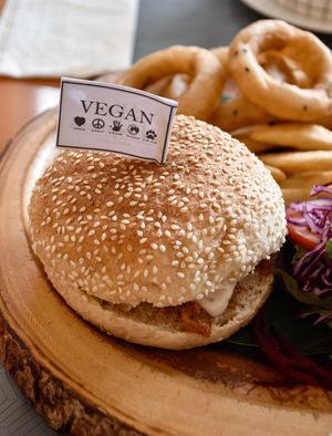 BBQ vegan cheese burger with onion rings, French fries, side salad  at May Veggie Home in Bangkok