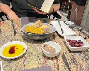 Olives, mushroom pate, olive oil and 4 kinds of bread as Couvert (they charge $4 per person)  at Jardineiro - Vegan Kitchen in Porto