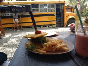 Vegan burger (plantain as buns, chickpea patty, onion, tomato, cucumber, salad) at En Todas in Quepos
