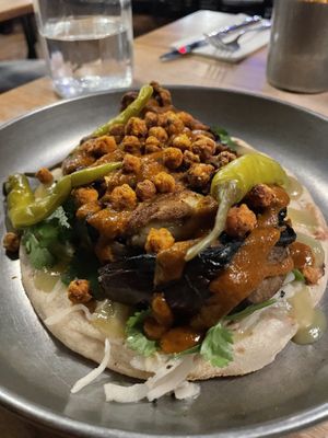 Flatbread kebab (Pickled White Cabbage, Picked Herbs, Green Apple & Jalapeno Sauce, Pickled Chillis) with Moroccan Spiced Aubergine, Charred Tomato & Garlic Ketchup, Roasted Chickp at Pint Shop in Cambridge