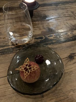 Appetiser dessert. Ice cream with crispy dough around and blackcurrant sauce   at Høst in Copenhagen