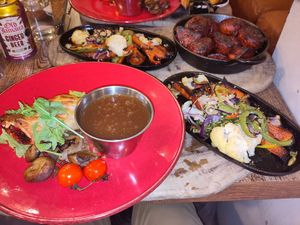 Beetroot, cheese, and squash wellington with gravy, grilled tomatoes, mushrooms, and roast veg side, with a side order of Marmite roasties! at The Old Bath Arms in Frome
