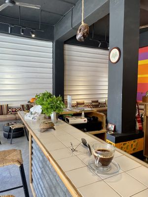 Sitting at the bar  at Frankfurter Supermarket & Cafe in Madaba