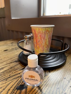 Hand sanitizer on table but no chilli peppers   at Pizza Projekt in London