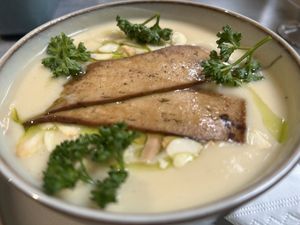 Cream white vegetable soup with smoked tofu  at Owca Cała in Poznan