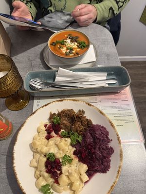 Pumpkin & tomato cream soup and gnocchi with “Goose” (jackfruit)  at Owca Cała in Poznan