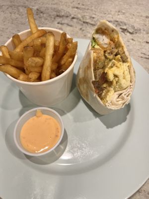 Half of the burrito and fries   at The Impossible Shop in Austin