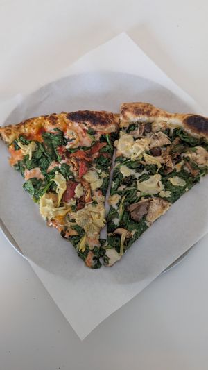 A slice of each of their vegan pizzas at Ignite Pizzeria in Vancouver