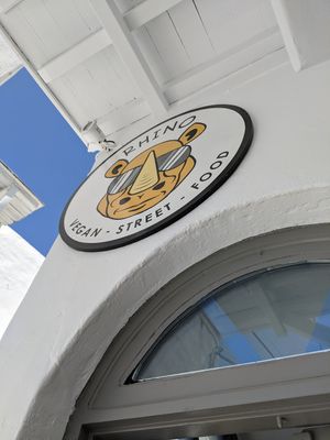 Easy to spot streetside sign at Rhino Vegan Beat in Mykonos