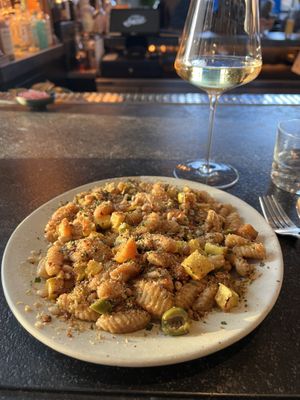 Gnochetti with butternut squash, lemons, olives, pine nuts and red pepper flakes and a glass of Chenin Blanc.  at Little Saint in Healdsburg