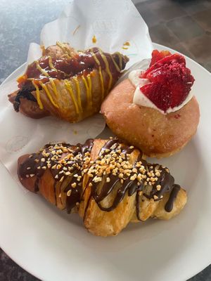 Sausage sizzle croissant, Strawberry lemonade filled donut, Snickers croissant at Belén Vegan Bakery in Wellington