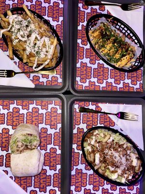 Garlic parm fries (top left), salt & chili tofu (top right), spicy chicken wrap (bottom left), and Caesar salad (bottom right)  #Veganuary at The Saucy Cow in Dublin