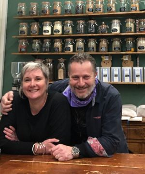 Ollie & Tree (Owners) in front of loose organic herbs and spices. Also selling loose teas and coffees, beans or ground.  at Bonitas Wholefoods in Stowmarket