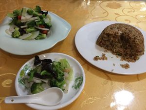 Suateed broccoli, lotus roots, wood ear mushrooms, red peppers. Brown rice bowl at Beijing Zheng Long Zhai in Beijing