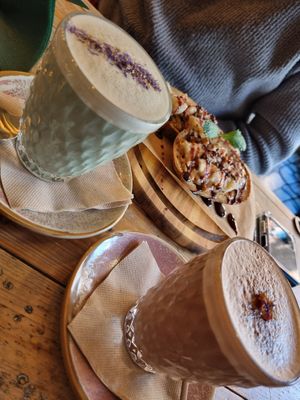 Blue Butterfly Pea & Guarana and Cacao drinks ft. PB & Banana toast in the background at VIBE Plant Based Cafe & Restaurant in Douglas