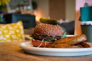 Vibe beetroot burger and potato wedges   at VIBE Plant Based Cafe & Restaurant in Douglas