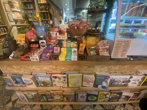 Selection of gluten free treats to snack on and books to read in cafe.   at VIBE Plant Based Cafe & Restaurant in Douglas