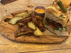 Burger, herby chips and some sort of delicious spicy (sriracha maybe) mayo.   at VIBE Plant Based Cafe & Restaurant in Douglas