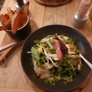Salad with sweet potato wedges at VIBE Plant Based Cafe & Restaurant in Douglas