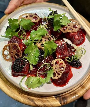 Blackberry &  balsamic tofu bites with dehydrated lotus crisps, spring onions, coriander   at VIBE Plant Based Cafe & Restaurant in Douglas