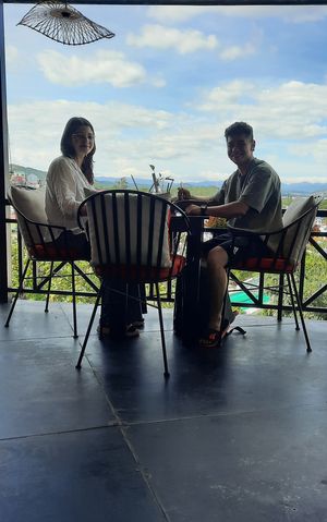 Happy couple on the balcony at Moto Laurie in Da Lat