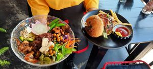 Buddha Bowl and Vegan 'Black Angus' Burger on their way to the table at Moto Laurie in Da Lat