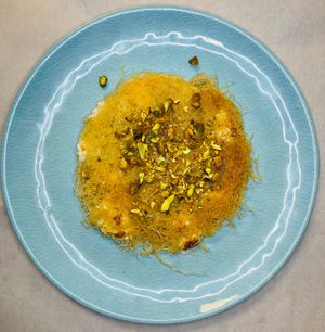 Vegan Knafa
A Palestinian dessert that is extremely popular in the Middle East for its crunchy, Rose Flower syrup-doused pastry. Topped with with pistachio nuts.  at Java Dive Organic Cafe - Mediterranean Restaurant in Bee Cave