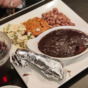 Mole plate w/jackfruit+ frijoles + arroz + macaroni ensalada at Viva Vegan in Colton
