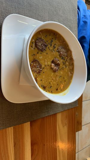Porotos con riendas y salchicha de la casa  at A Fuego in Copiapo
