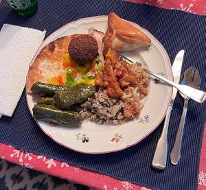 Manaeesh veggie flatbread, falafel, small spinach pie, eggplant and chickpeas, modrdara (lentils and rice), and grape leaves.  at New Yasmeen Bakery in Dearborn