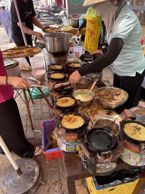 Cooking the pancakes and ‘eggs’ over charcoal   at Mãn Tự in Ho Chi Minh City