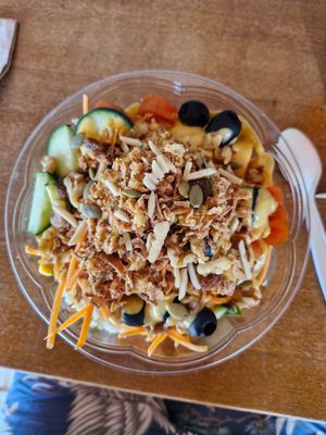 Spinach, couscous, lentils, mango dressing, cucumber, tomatoes, black olives, topped with mixed nuts and crispy onions 😋 at The Bowl Haus in Lanzarote