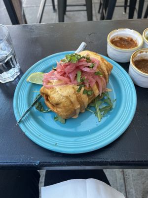 Chimichanga with potatoes, black beans, vegan crema, and pickled onions.   at Black Sheep in Bellingham