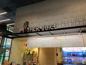 Sign, wall menu, and drink case at Mother Juice - High St Place in Boston