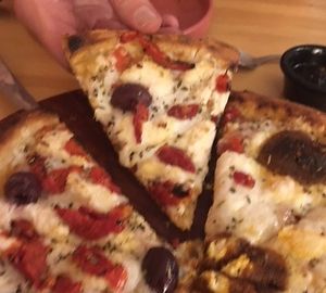 What you're seeing on that slice is a black olive and sundried tomatoes.  at Coral Vegan Pizza in Playa Del Carmen