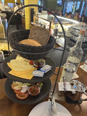 Vegan breakfast: cheese, butter, slice bread, hard rolls, tomato compote, roasted mushrooms, avocado, microgreens  at Funkhaus in Cologne