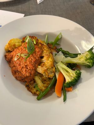 Roasted cauliflower with an arm and tomato sauce witches Spanish, Roast potatoes and steamed veg at Eat To The Beat in Aylesbury