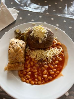 Baked potato vegan cheese and beans. Plus homemade vegan sausage roll at Eat To The Beat in Aylesbury