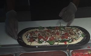 The Assembly of the pizza I ordered a vegan cheese, Vegan pepperoni,  spicy chickpeas and vegan sausage. Top with all the veggies I wanted. at & PIZZA in Nottingham