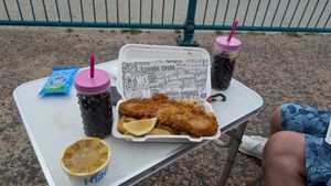 We had our little camper set up but there are two picnic tables outside the shop or you walk 1 min and eat on the beach! at Walkers Quality Fish & Chips in Aberdovey