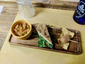 Fagioli all'uccelletto, torta al testo con stracchino e rucola, oliva ascolana at Animo Cucina Naturale in Brescia