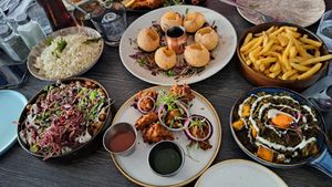 Top L-R - Jeera Rice, Golgappa, Chips. Bottom L-R - Samosa chaat (amazing), vegetable pakora, my friend’s vegetable curry (not vegan)  at Murphy's Pakora Bar in Glasgow