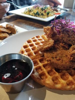 "Chicken & Waffles with side of breakfast sausage... Chef's Scramble with tofu in the background at Fern Flavors from the Garden in Charlotte