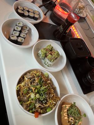Squeaky bean mock duck yakisoba, inari taco, veggie volcano roll, avocado and cucumber maki  at Yo! Sushi in Bristol