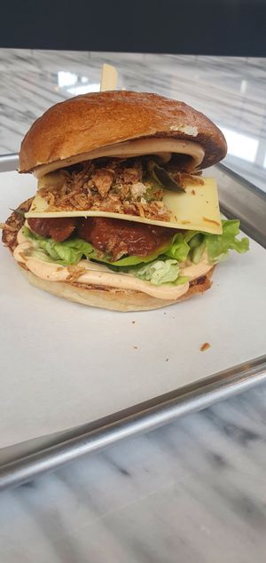 Buffalo Vurger: Crispy ‘chicken’ patty dipped in buffalo hot sauce, topped with vegan mozzarella slice, gherkins, crispy onions and house-made baconnaise. at The Vurger Co in Manchester