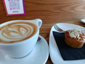Oat latte and cake with almond slices at Kaph in Dublin