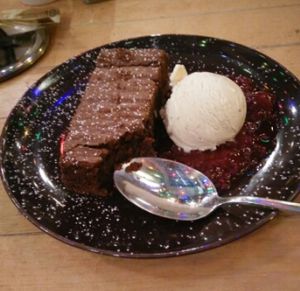 Chocolate cake with berry coulis and vanilla ice cream.  at Saramago Cafe Bar in Glasgow