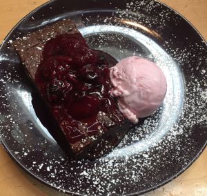 chocolate cake with raspberry ice cream at Saramago Cafe Bar in Glasgow